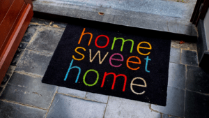 A black doormat with a home sweet home text in it